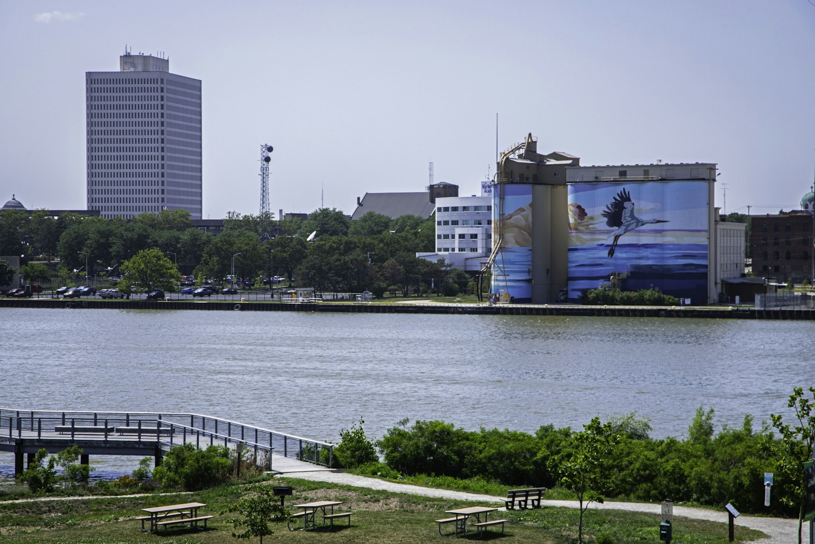 Glass City Metropark lawn, riverwalk and large bird mural across the Maumee River
